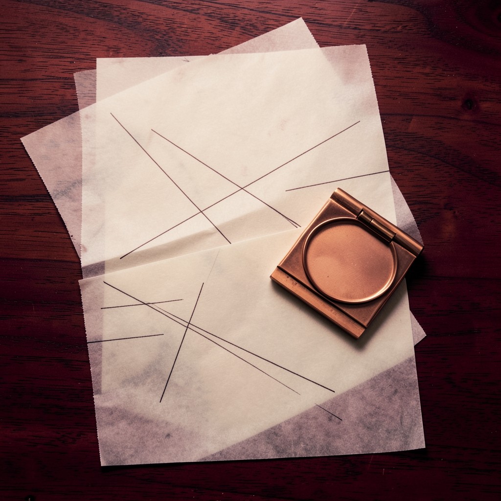 Two translucent sheets of chart lines layered on dark wood, showing a pullback meeting a prior range